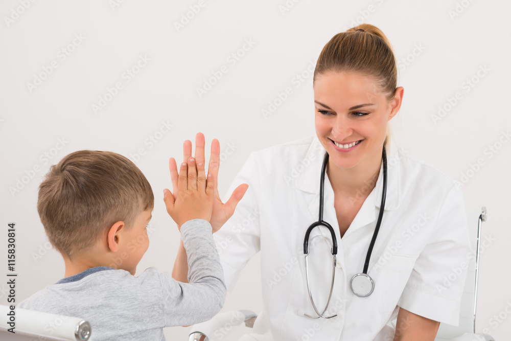Doctor Giving High Five To Boy