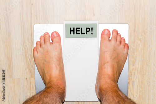 Closeup of man's feet on weight scale