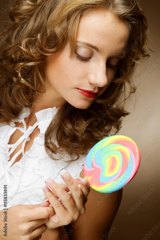 curly  girl with a lollipop in her hand 