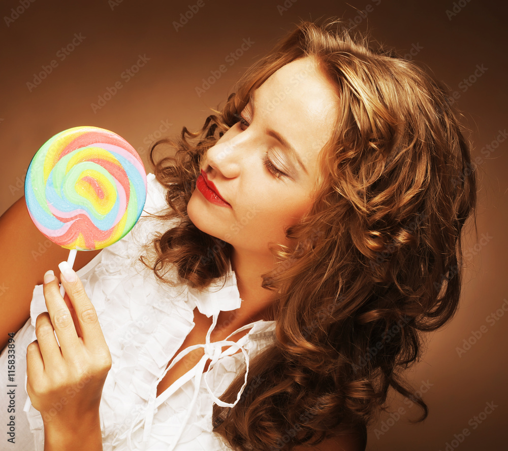 curly  girl with a lollipop in her hand 