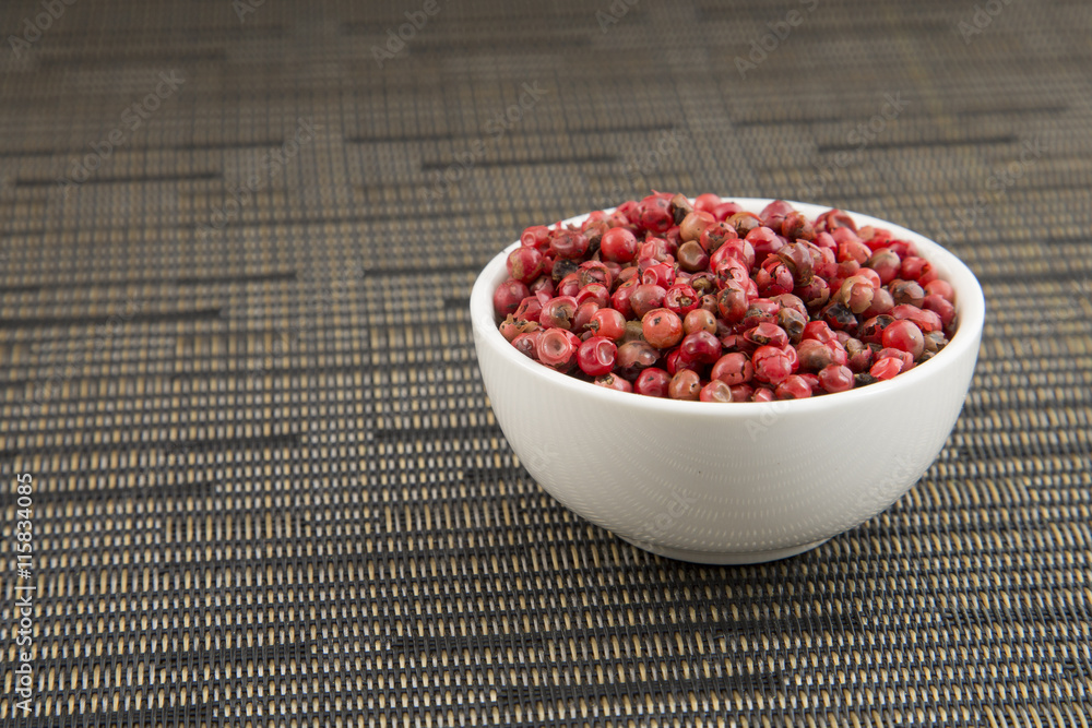 red peppercorns in white bowl red peppercorns in white bowl