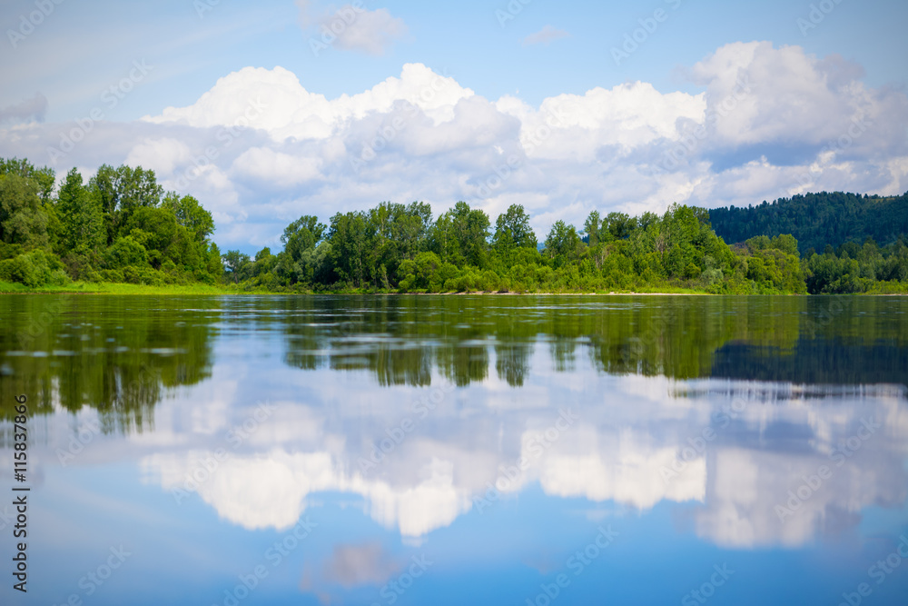 Beautiful landscape with blue sky and white clouds reflected in