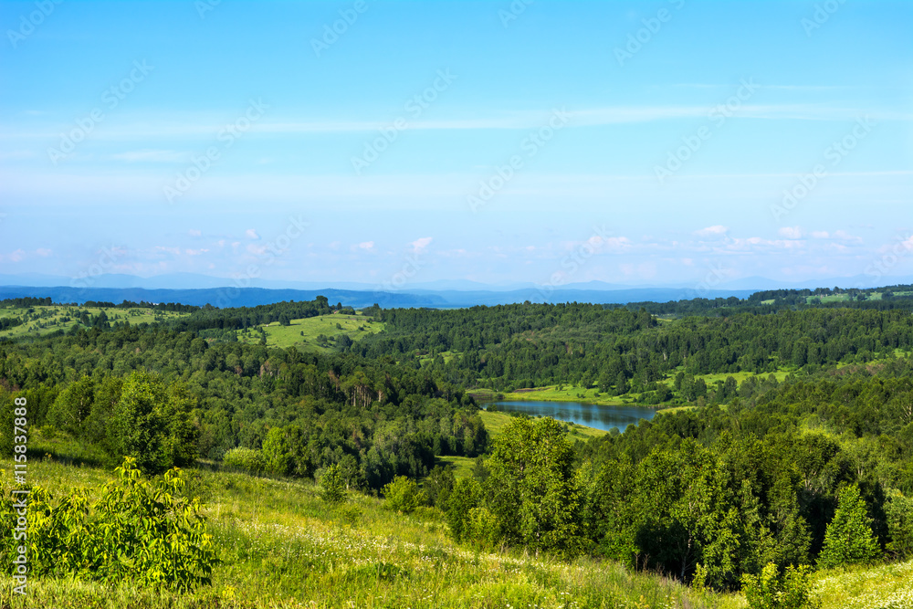 Summer beautiful hills landscape with blue lake Summer beautiful hills landscape with blue lake