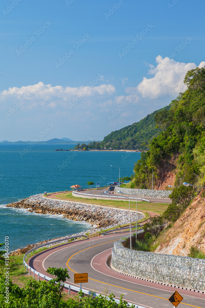 Scenic road beside deep blue sea and blue sky