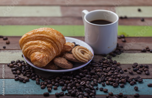 Cookies with coffee beans on wooden background