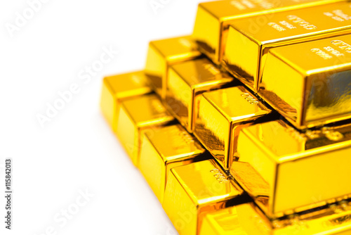 pieces of gold bars stacked up on a white background