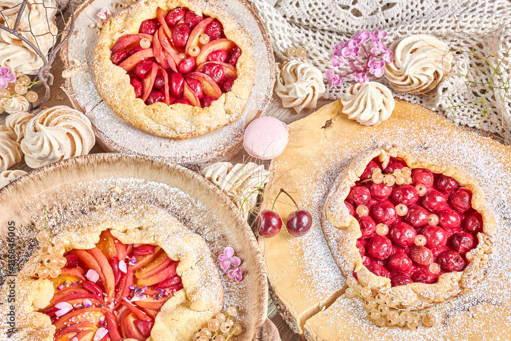 Rustic fruit tarts and meringues, homemade pastry, pastel colors.