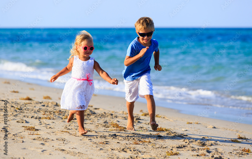 little boy and girl running at beach little boy and girl running at beach