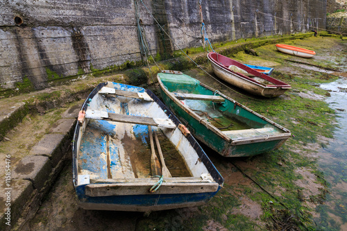 STAITHES, ENGLAND - JULY 12: Small, wooden fishing boats in Staithes Beck. In Staithes, North Yorkshire, England. On 12th July 2016.