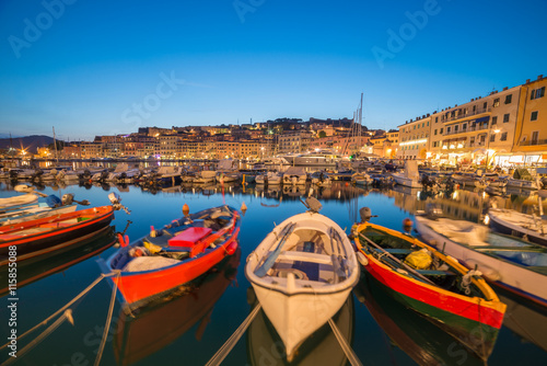 Traditional boats in Portoferraio port and coastline of Elba island in Italy photo