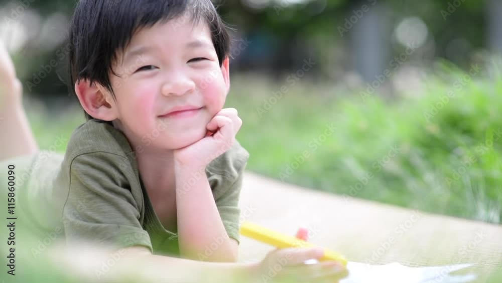 Cute Asian child drawing picture with crayon Cute Asian child drawing picture with crayon