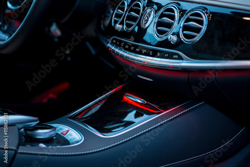 Luxury car interior details. Middle console with air and climate controls © Room 76 Photography