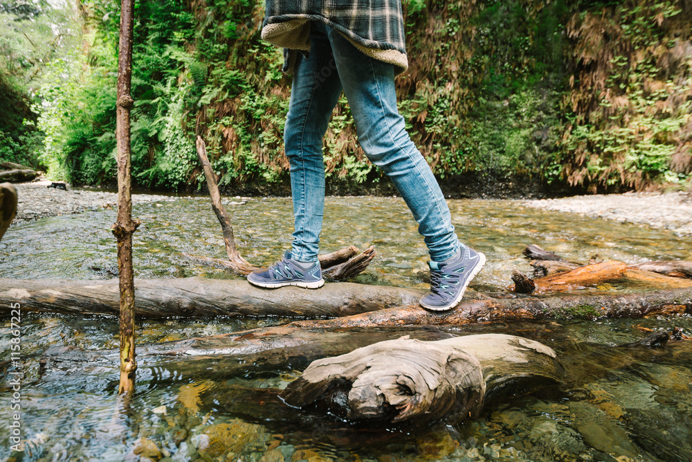 Woman is hiking in Fern canyon at summer day. Woman is hiking in Fern canyon at summer day.