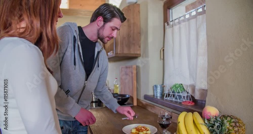 A man and woman come close to the kitchen counter and they start eating lunch. A man takes a spoon of the dish and puts it in his girlfrien's mouth. Close-up shot.
 photo