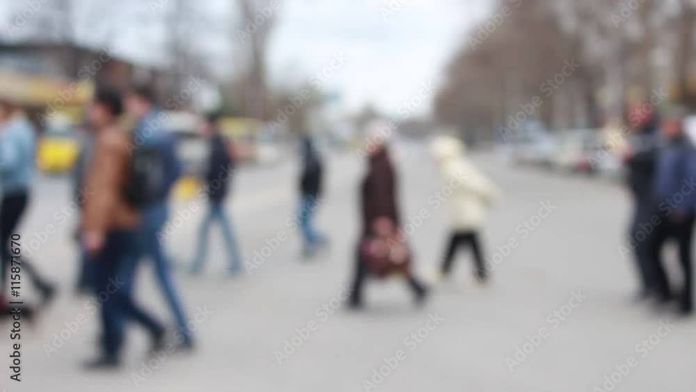 People crossing a road while green light is on People crossing a road while green light is on