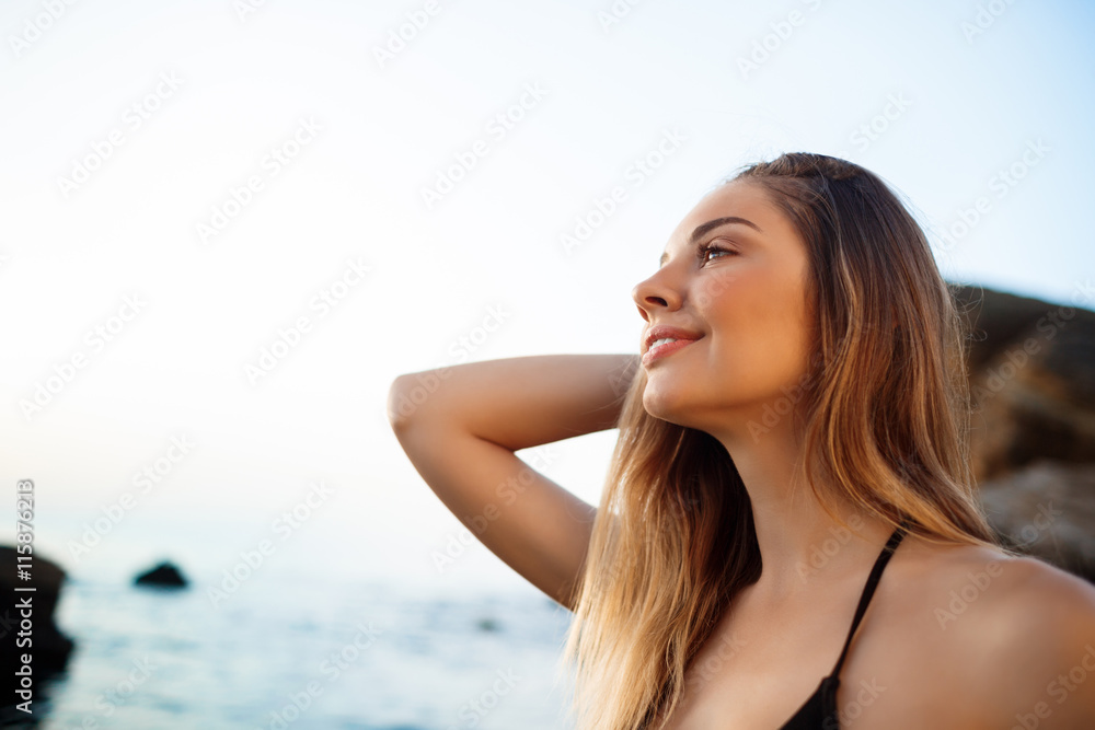 Beautiful young girl rests at morning beach