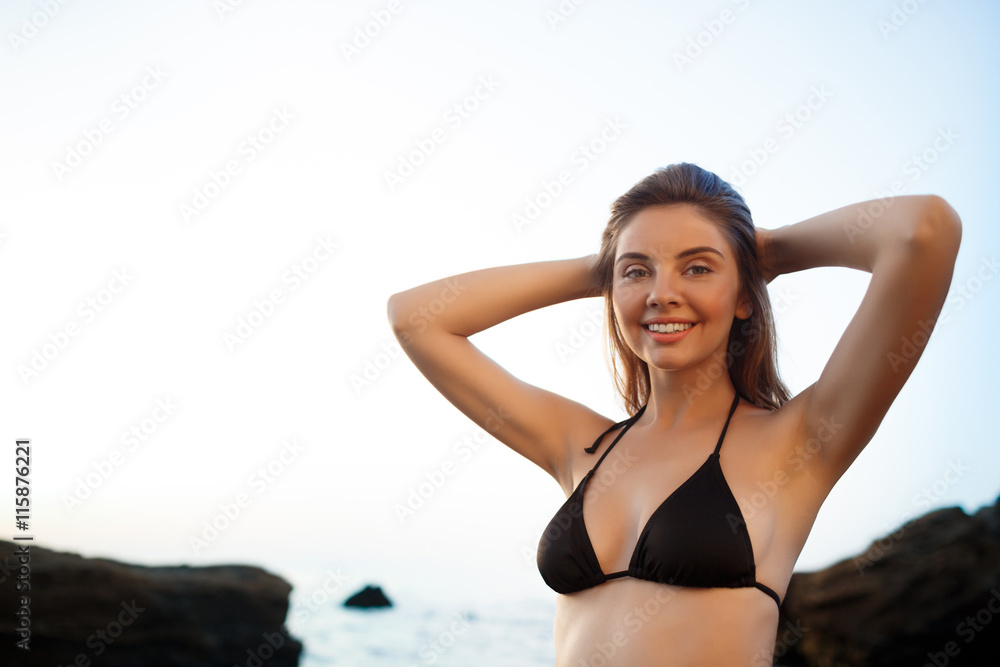 Beautiful young cheerful girl rests at morning beach Beautiful young cheerful girl rests at morning beach