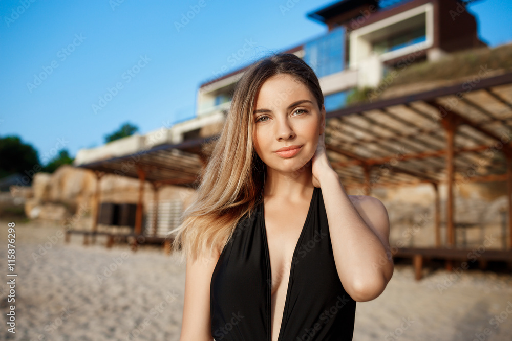 Beautiful young girl rests at morning beach