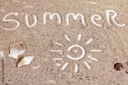 "summer" handwritten on sand