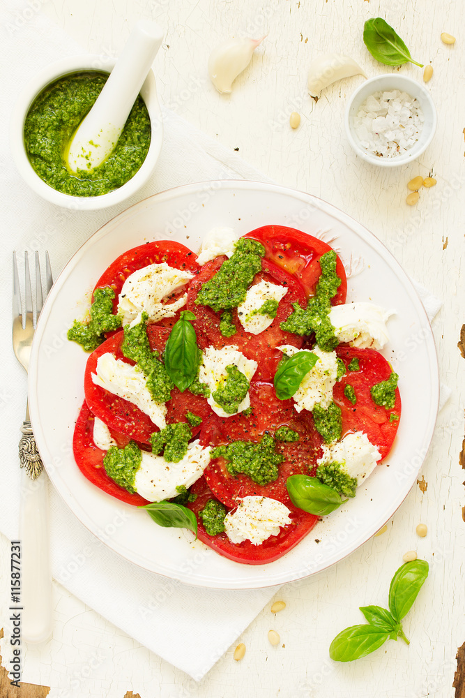 Delicious salad of tomato, mozzarella and pesto. Delicious salad of tomato, mozzarella and pesto.