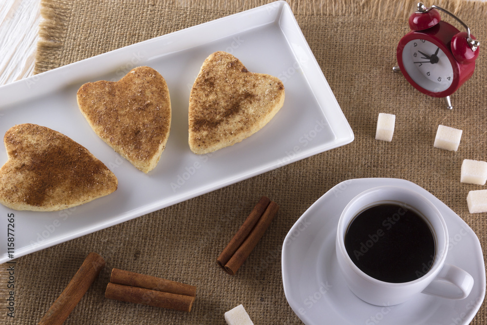 Cup of coffee with cinnamon cookies.