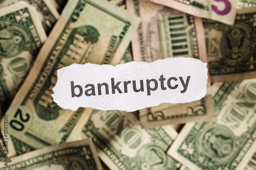 Focus on the word BANKRUPTCY on piece of torn white paper with blur background