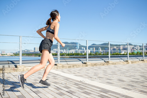 Young woman running in a city