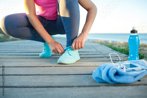 Running shoes - woman tying shoe laces