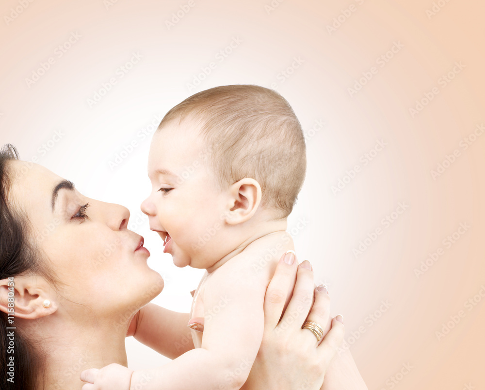happy mother kissing adorable baby