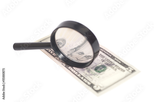 Five dollar bill with a magnifying glass