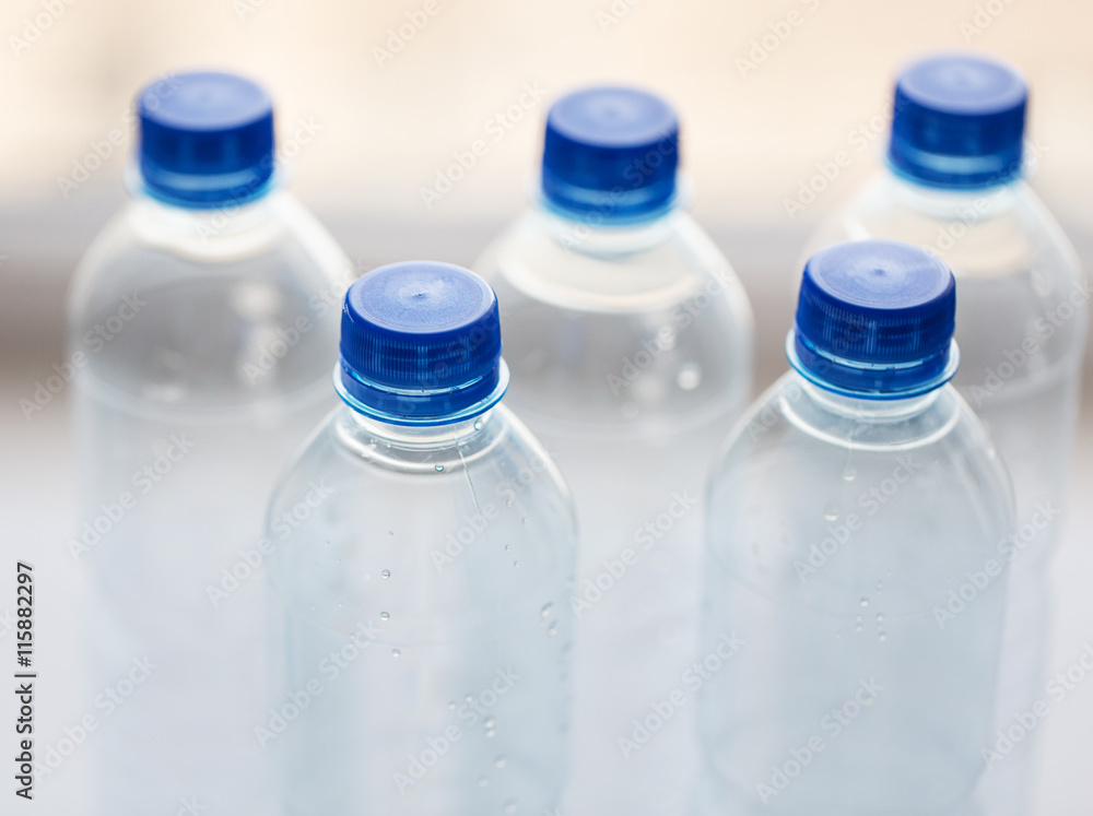 close up of bottles with drinking water on table close up of bottles with drinking water on table