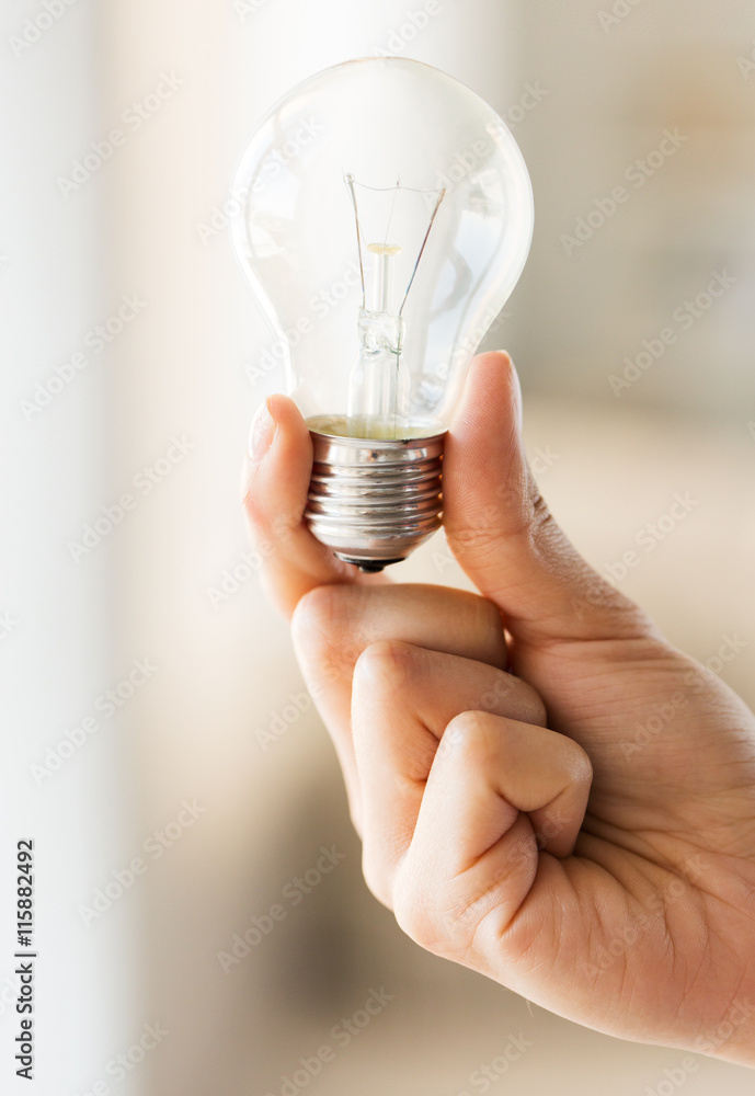 close up of hand holding edison lamp or lightbulb - obrazy, fototapety, plakaty 
