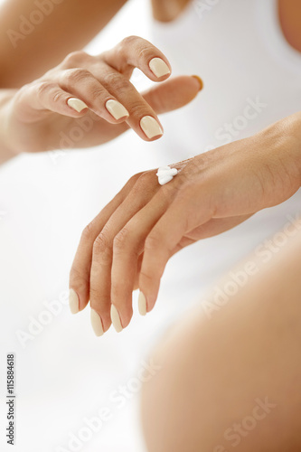 Fotografie Hand Cream. Close Up Of Woman's Hands Applying Lotion On Skin