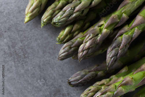 Bunch of asparagus on a table. Uncooked pile raw for organic, vegetarian cuisine, delicious fresh, healthy ingredient. Closeup and copy space.
