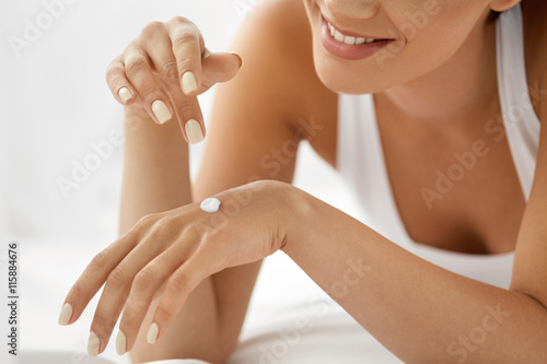 Woman Hand Cream. Close Up Of Beautiful Girl Applying Lotion