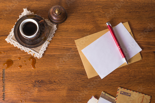 Envelopes on a wood background with a cup of coffee