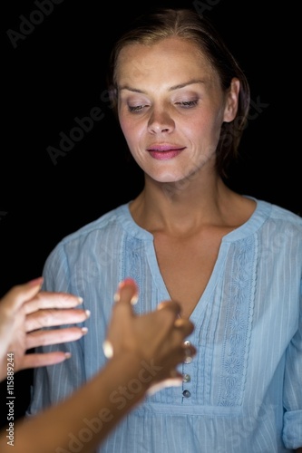 Fotografie Cropped image of hypnotist hypnotizing woman