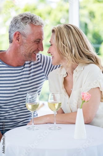 Romantic smiling mature couple with white wine