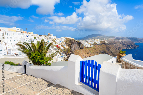 View of Imerovigli village with typical white Greek houses and blue gate on Santorini island, Greece