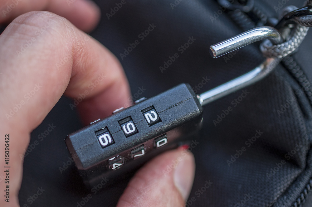 Hand opens suitcase combination lock Hand opens suitcase combination lock