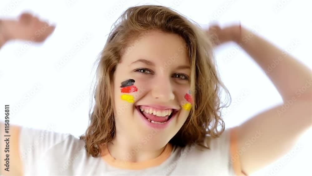 Girl with German flag on her face smiling at the camera, slow motion Girl with German flag on her face smiling at the camera, slow motion