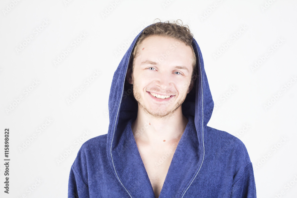 Happy young handsome man in bathrobe with hood. Happy young handsome man in bathrobe with hood.