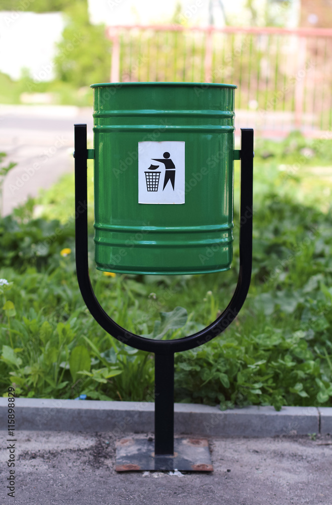 iron green trashcan on the street, summertime iron green trashcan on the street, summertime