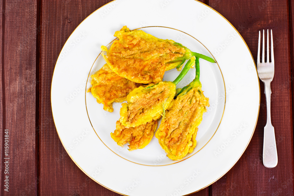 Flowers of Zucchini, Fried in Batter on a Wooden Background Flowers of Zucchini, Fried in Batter on a Wooden Background