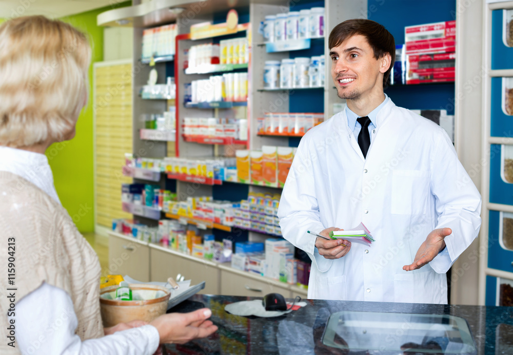Experienced pharmacist counseling female customer