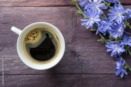 Healthy herbal drink. Chicory and blue flowers on wooden table. Top view