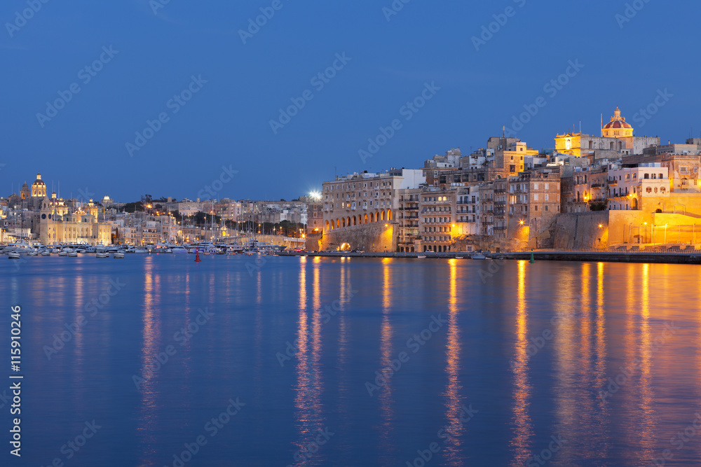 Idyllic view of Malta's Tricity area with lights glowing in the sea 