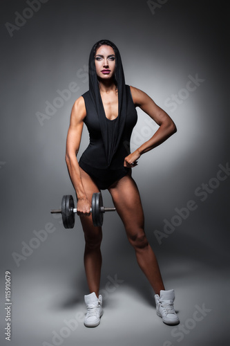 studio shot of perfect body of bodybuilder female;