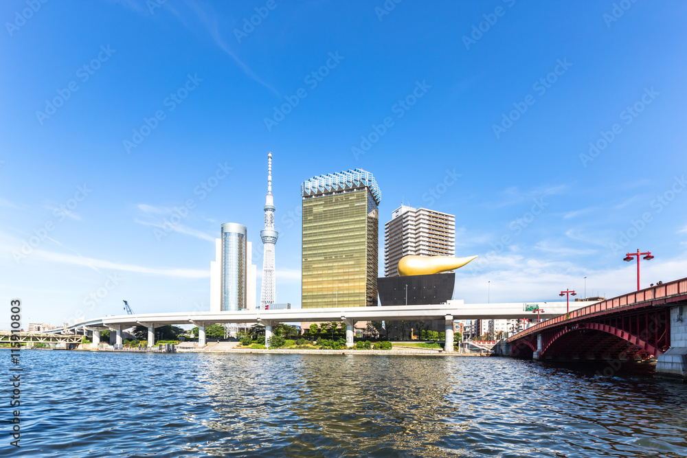 bridge,water,modern buildings and tokyo tower in blue sky