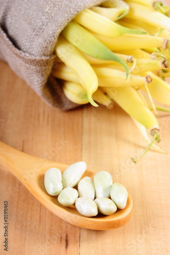 Fototapeta Naklejka Na Ścianę i Meble -  Seeds and heap of yellow beans in jute bag, healthy food